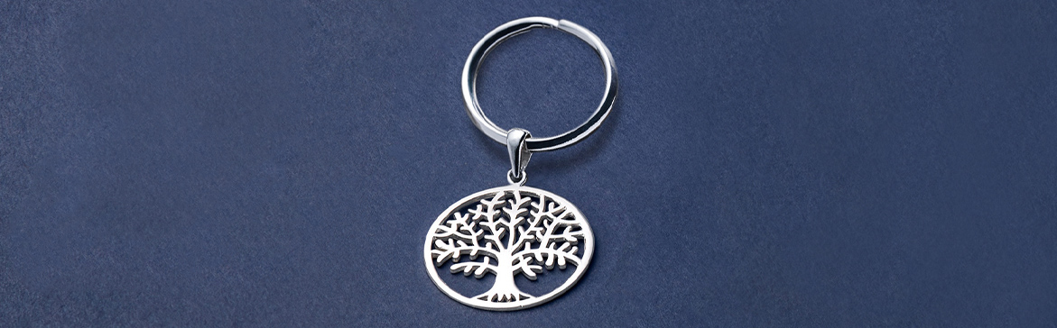 A Sterling Silver Tree of Life Keyring on a Blue Background